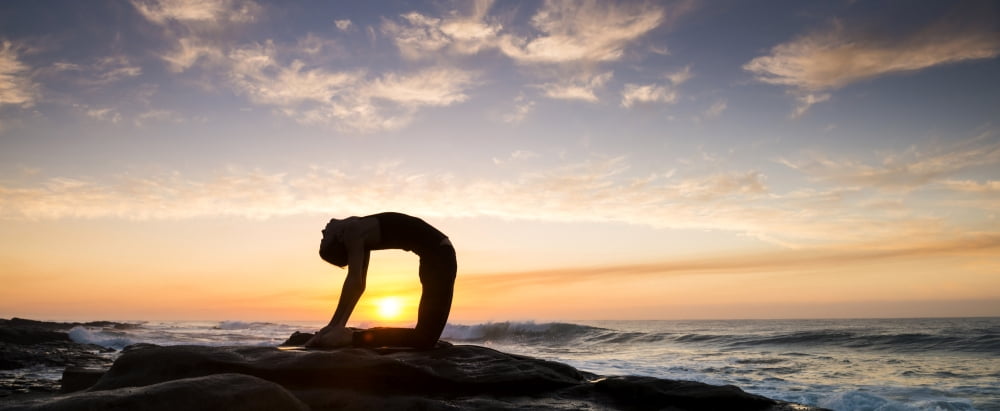 Woman doing yoga (Camel Pose) on the coast at sunrise Tzaneen Limpopo Province South Africa Canvas Art - Panoramic Images (36 x 12)