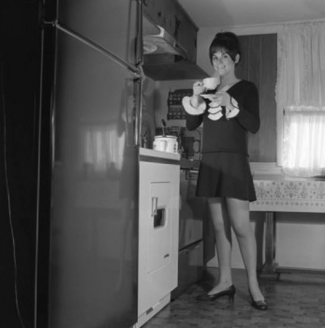 Woman drinking tea in kitchen Canvas Art - (18 x 24)