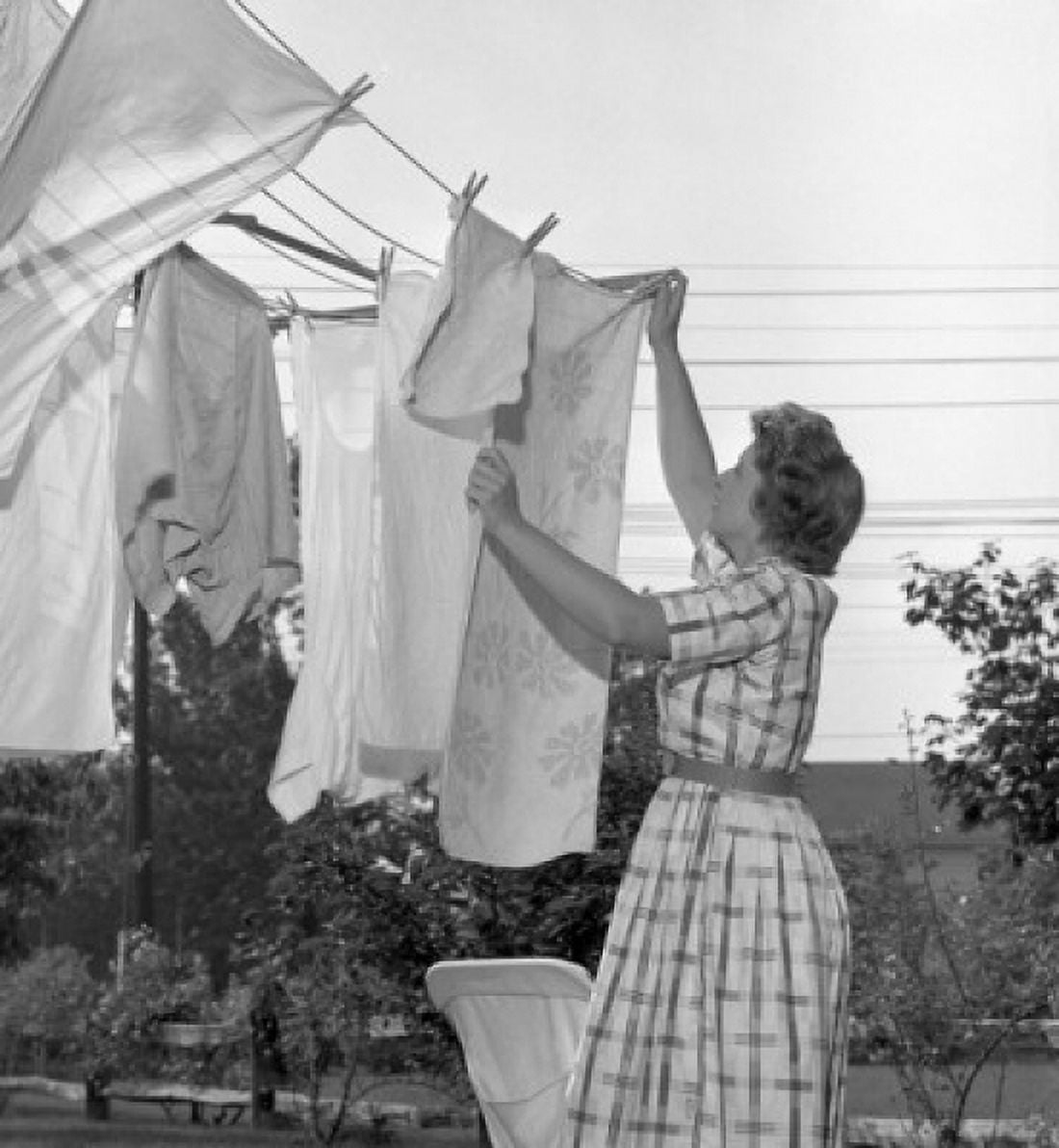 Woman hanging laundry Canvas Art - (18 x 24)