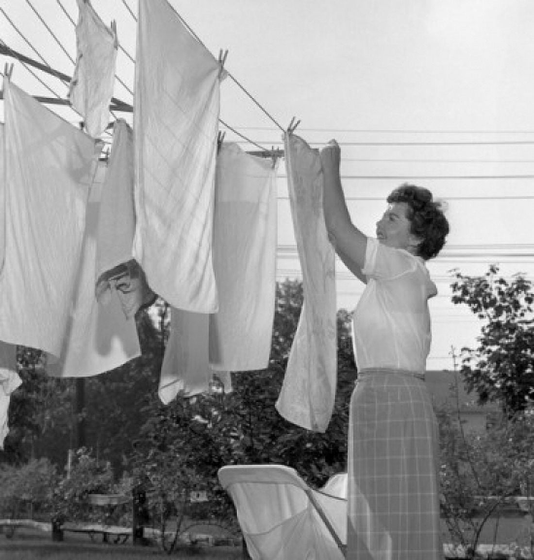 Woman hanging laundry Canvas Art - (18 x 24)