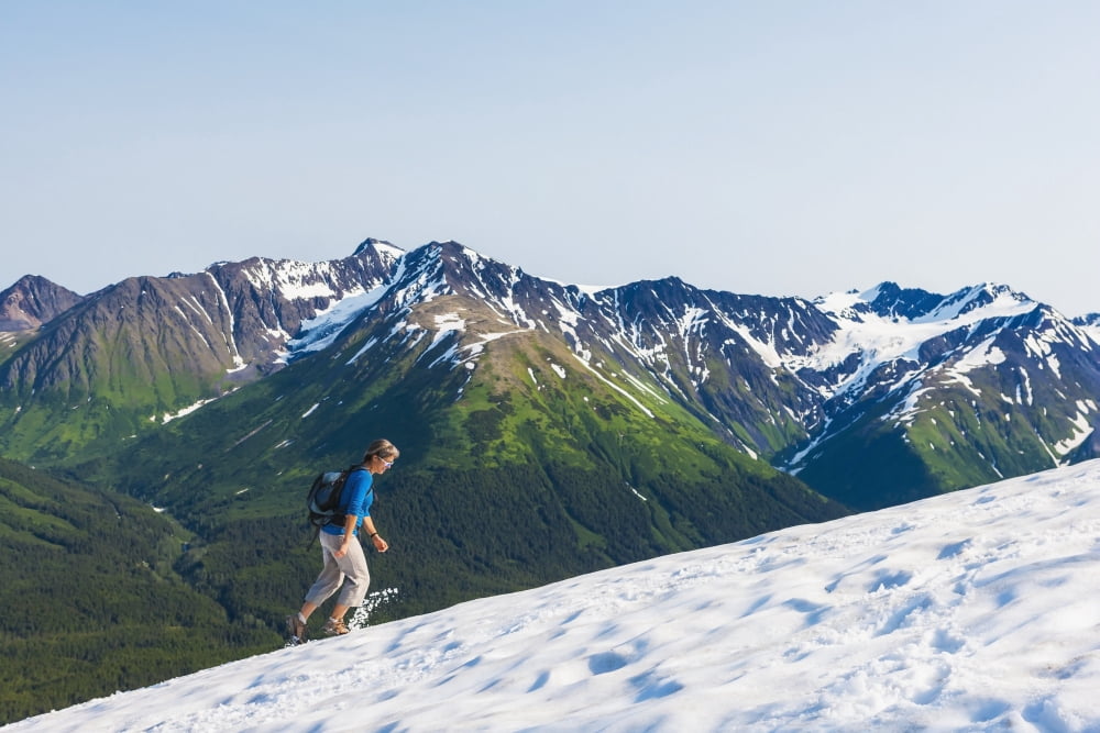 Woman hiking on a snowfield on Mt Alyeska with view of the Chugach Mountains Girdwood Southcentral Alaska Canvas Art - Michael DeYoung Design Pics (38 x 24)
