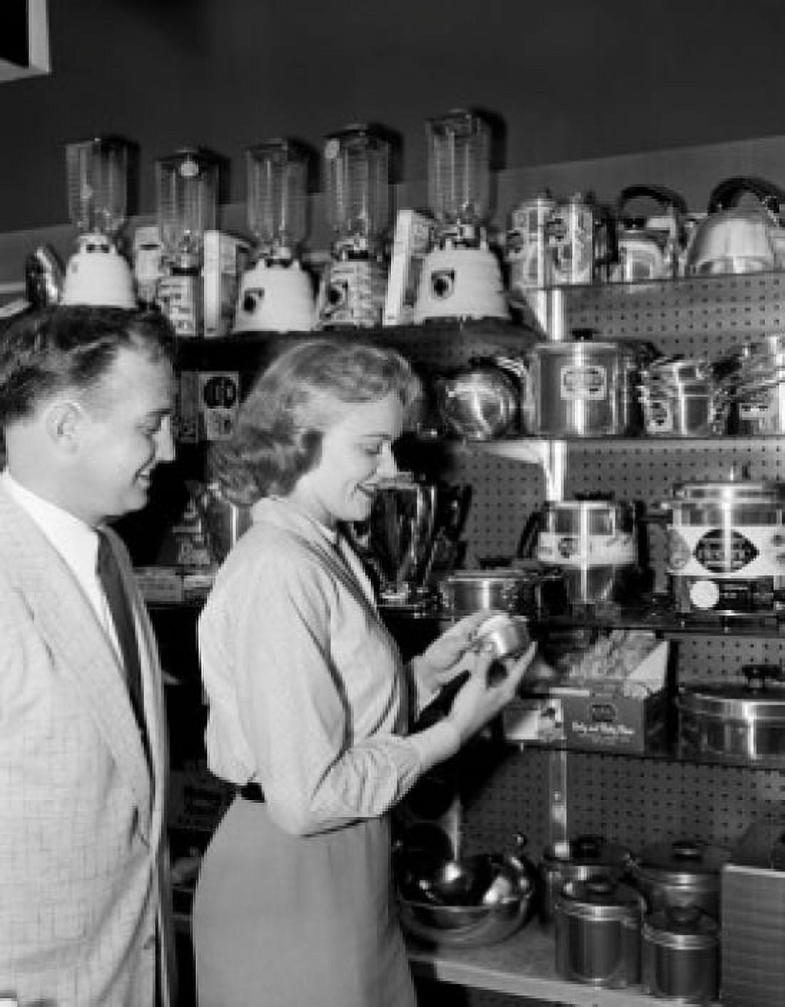 Woman in shop with kitchen utensils Canvas Art - (24 x 36)