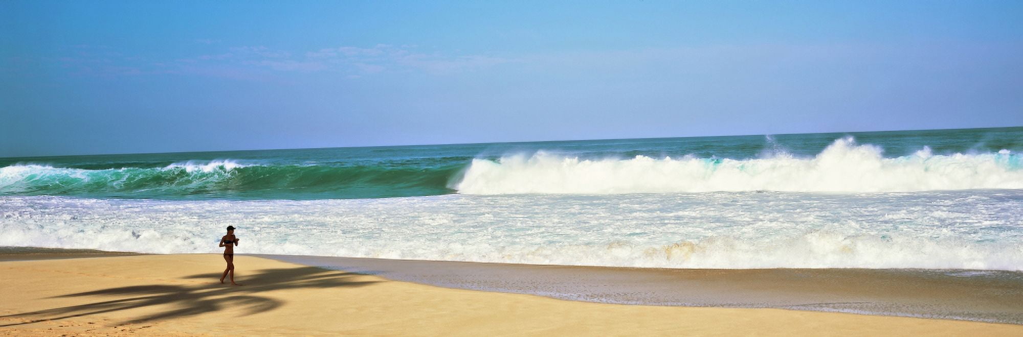 Woman jogging on the beach Oahu Hawaii USA Canvas Art - Panoramic Images (36 x 12)
