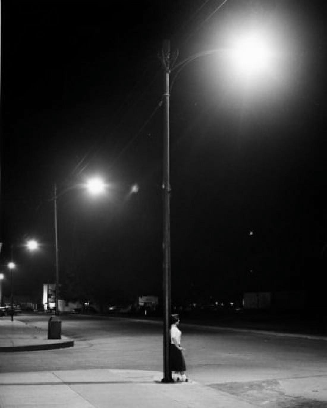 Woman leaning on lamp post in street Canvas Art - (18 x 24)