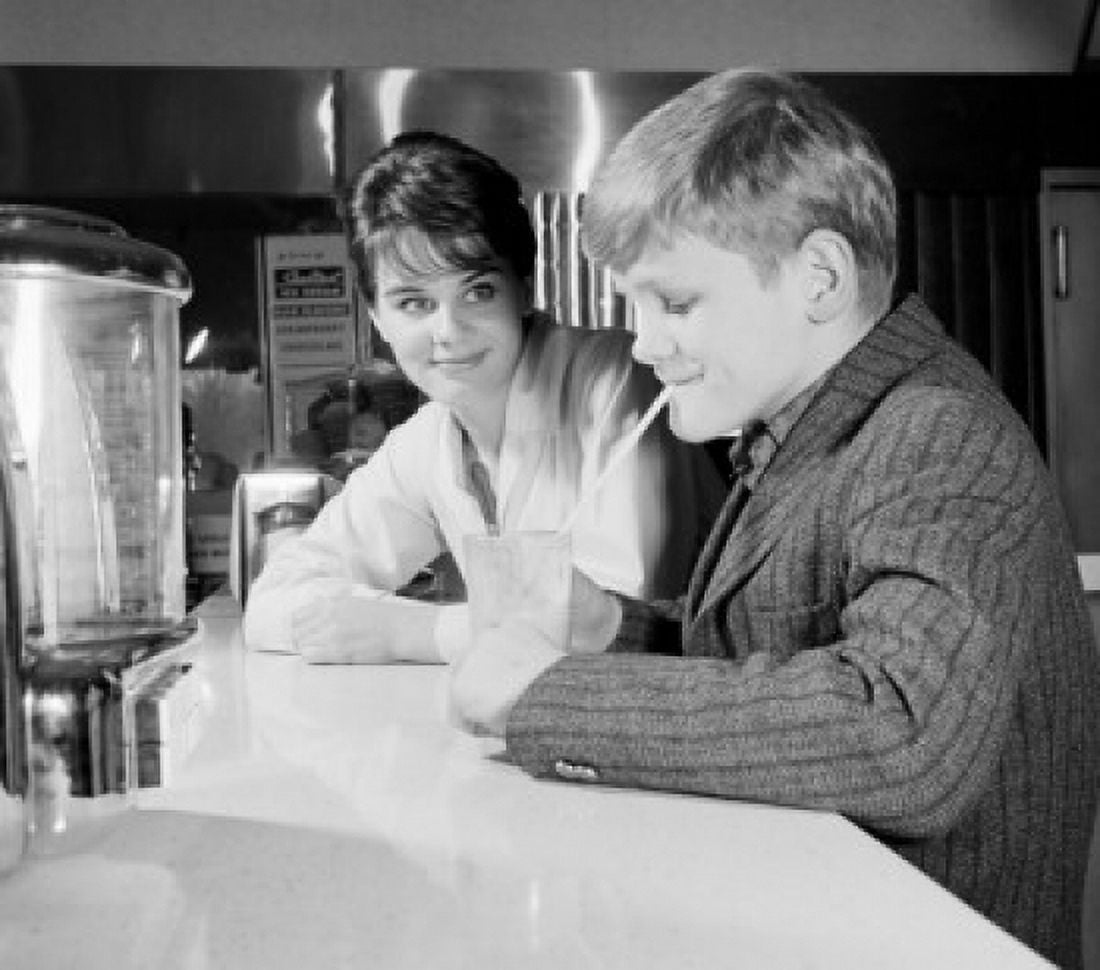 Woman looking at boy drinking milk shake Canvas Art - (18 x 24)