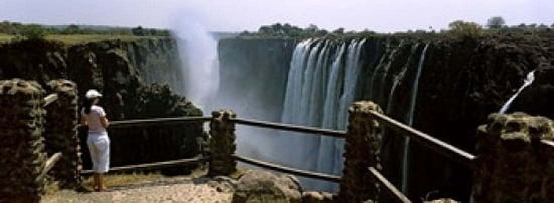 Woman looking at the Victoria Falls from a viewing point Zambia Canvas Art - Panoramic Images (18 x 7)