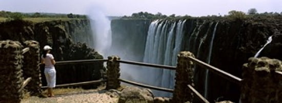 Woman looking at the Victoria Falls from a viewing point Zambia Canvas Art - Panoramic Images (36 x 13)