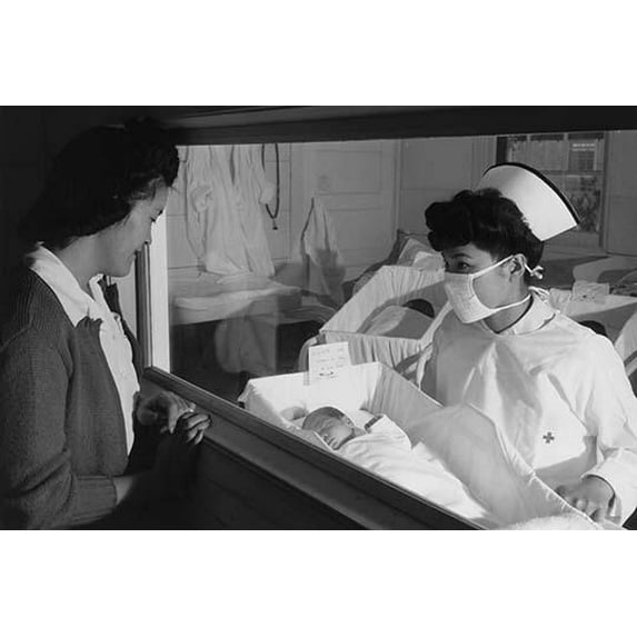Woman looking through window at baby being held by nurse in maternity ward. Ansel Easton Adams was an American photographer, best known for