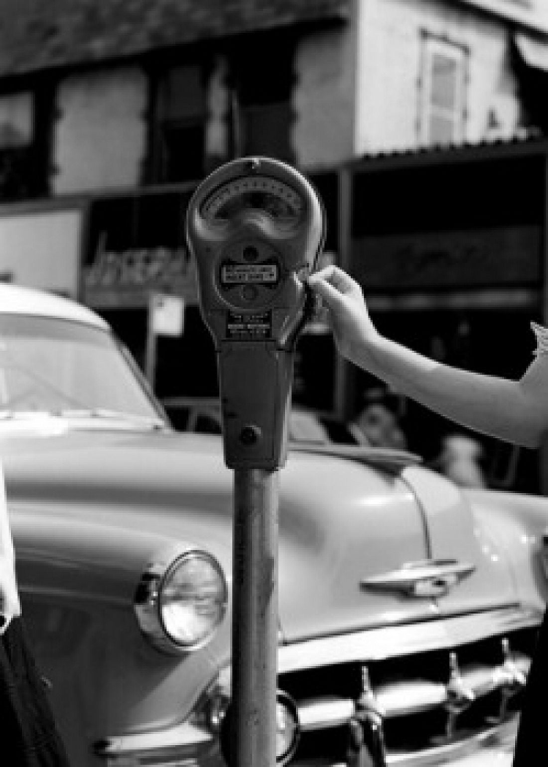 Woman paying parking meter Canvas Art - (18 x 24)