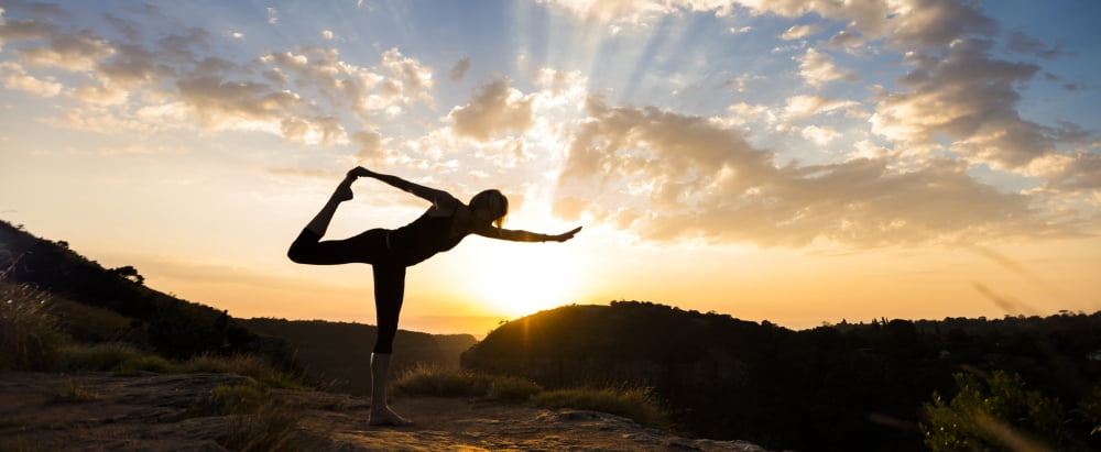 Woman performing standing bow pulling yoga pose at sunrise Kloof Kwazulu-Natal South Africa Canvas Art - Panoramic Images (36 x 12)