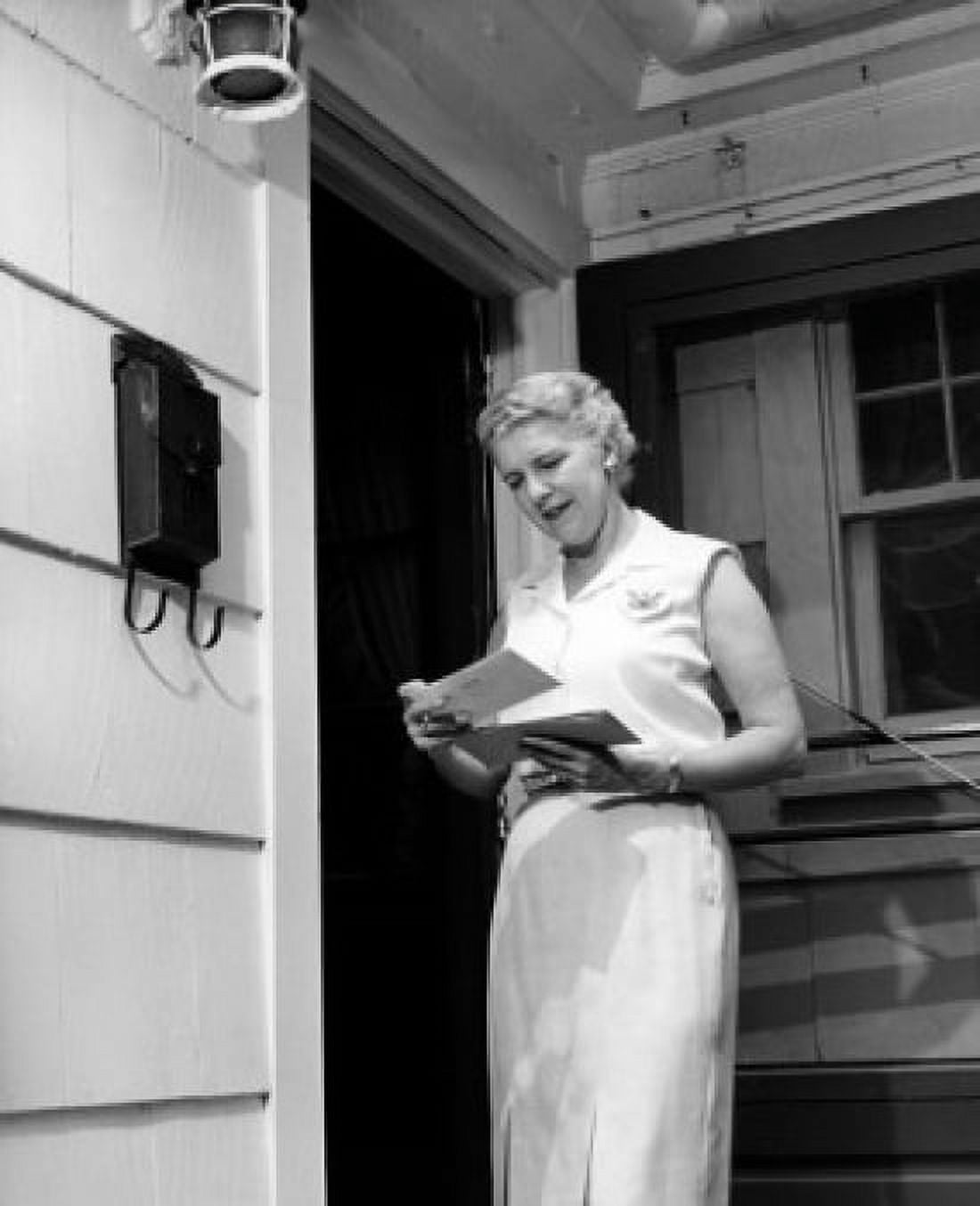 Woman reading letter on porch Canvas Art - (24 x 36)