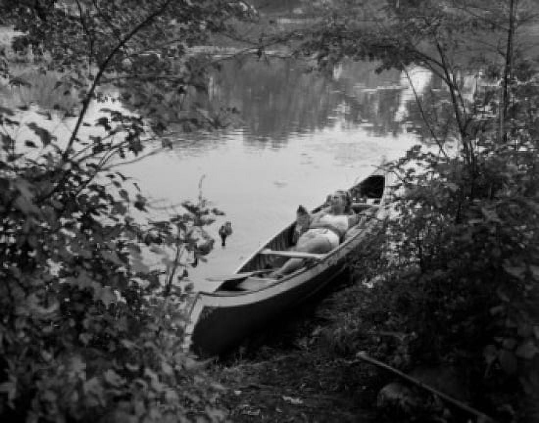Woman relaxing in canoe Canvas Art - (24 x 36)
