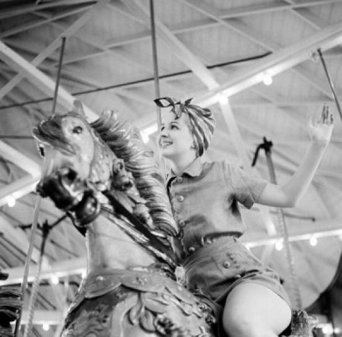 Woman riding merry go round Canvas Art - (24 x 36)