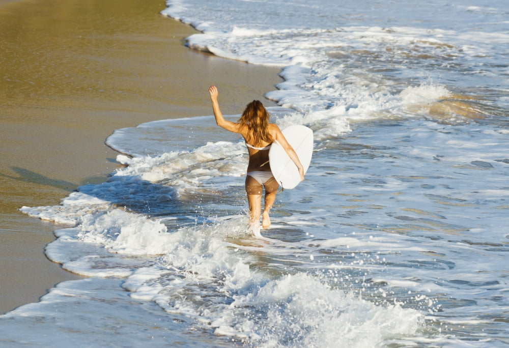 Woman running along beach with surfboard Tarifa Cadiz Province Andalusia Spain Canvas Art - Ben Welsh Design Pics (36 x 24)