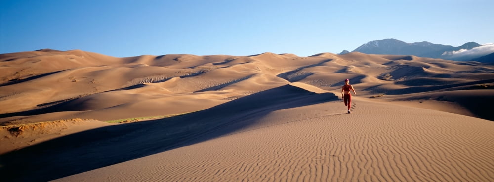 Woman running in the desert Great Sand Dunes National Monument Colorado USA Canvas Art - Panoramic Images (36 x 12)