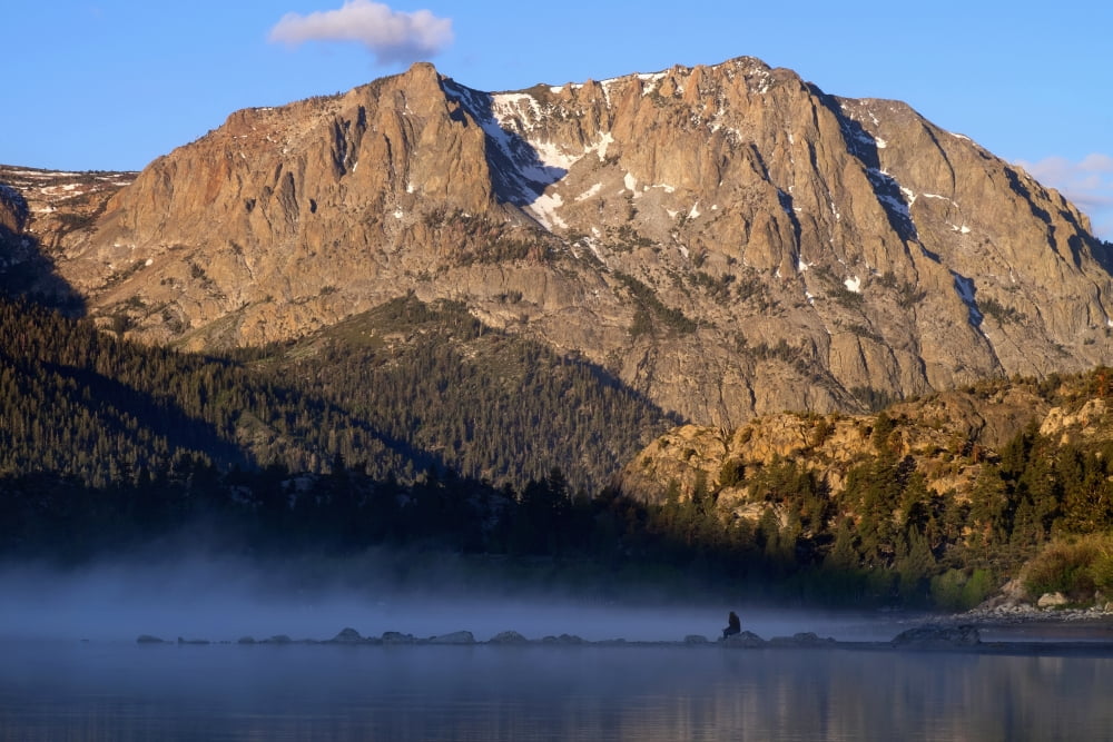 Woman sits on rock and views sunrise over June Lake Mono Basin California United States of America Canvas Art - Gina Bringman Design Pics (38 x 24)