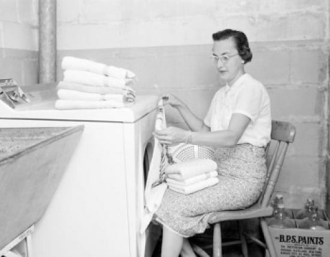 Woman sitting and folding towers Canvas Art - (18 x 24)