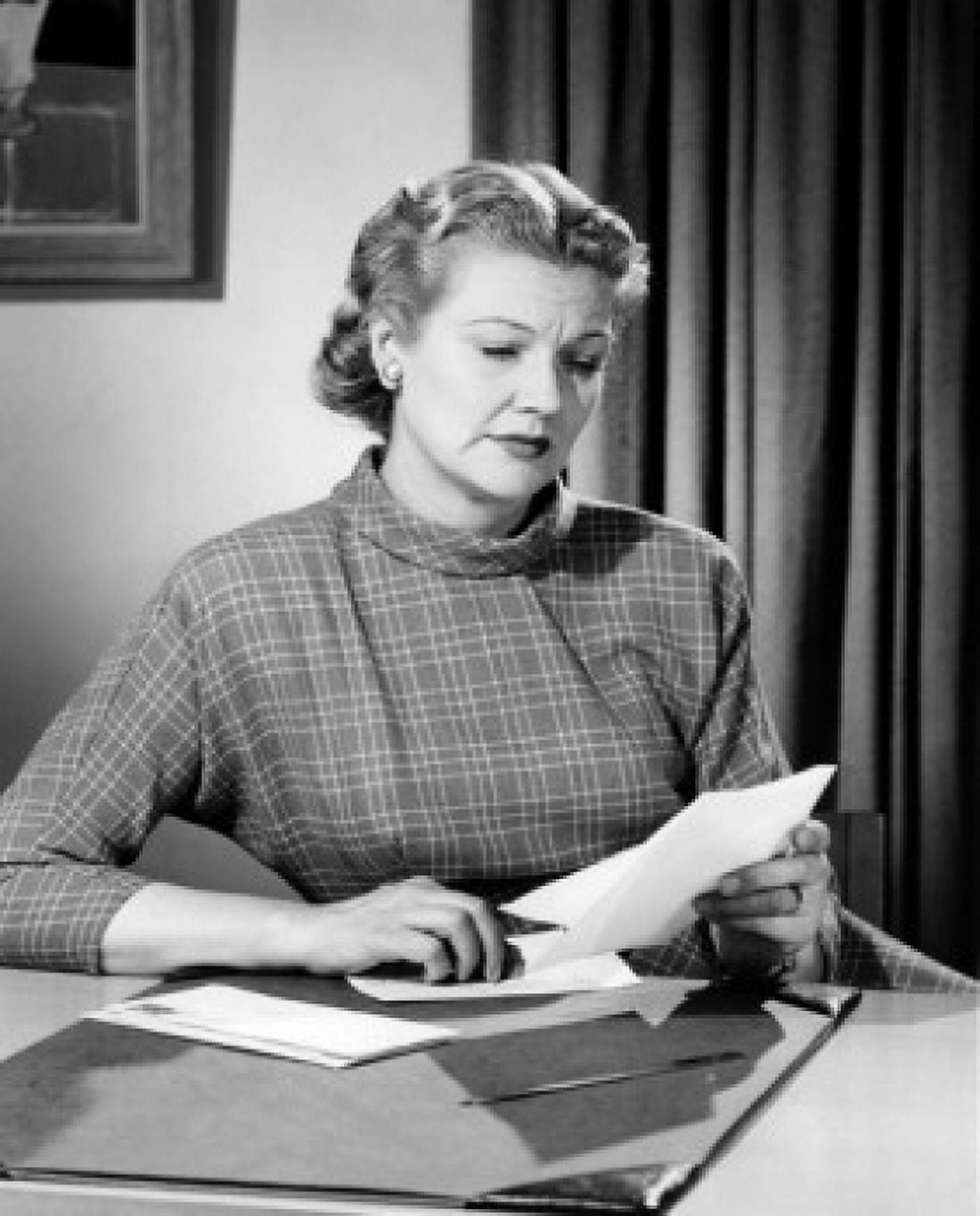 Woman sitting at desk reading letter Canvas Art - (24 x 36)