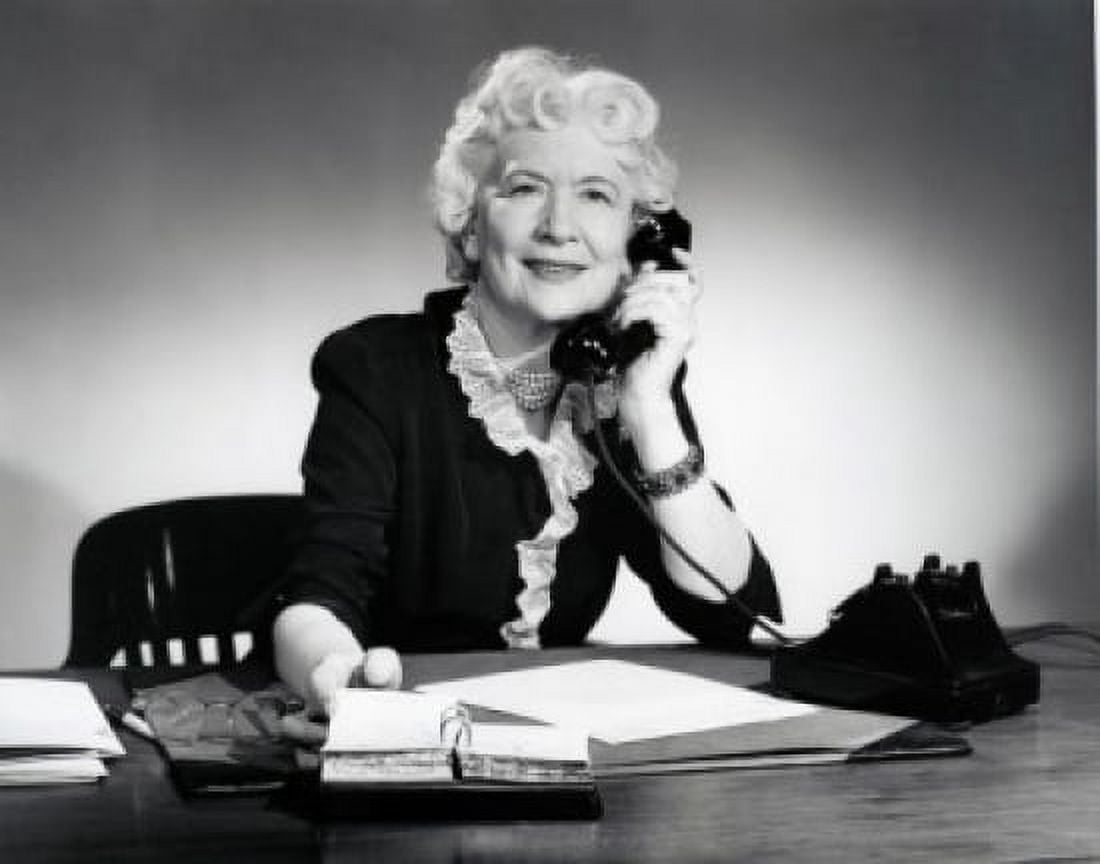 Woman sitting at desk talking on phone Canvas Art - (24 x 36)