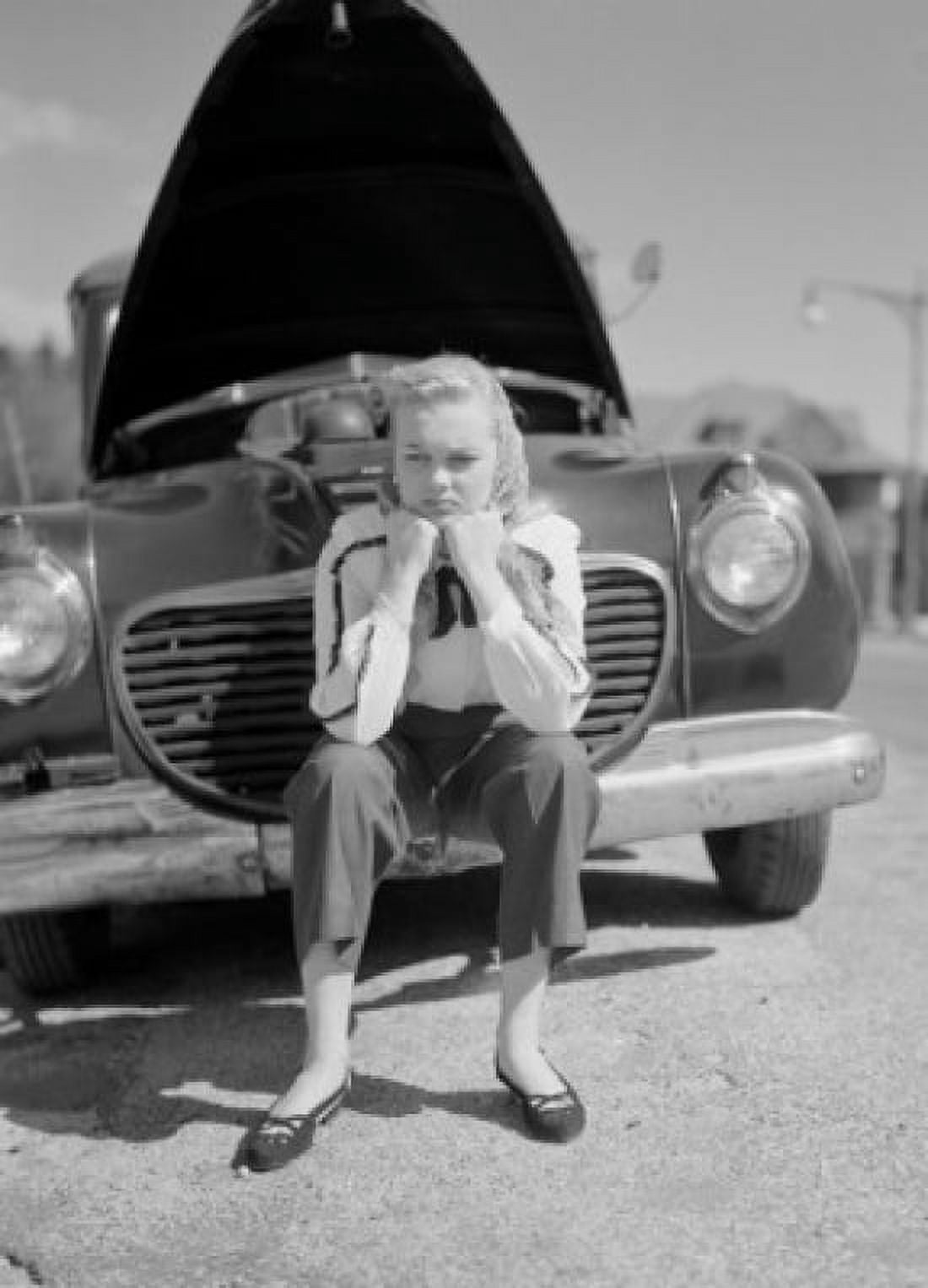 Woman sitting on bumper of broken Canvas Art - (18 x 24)
