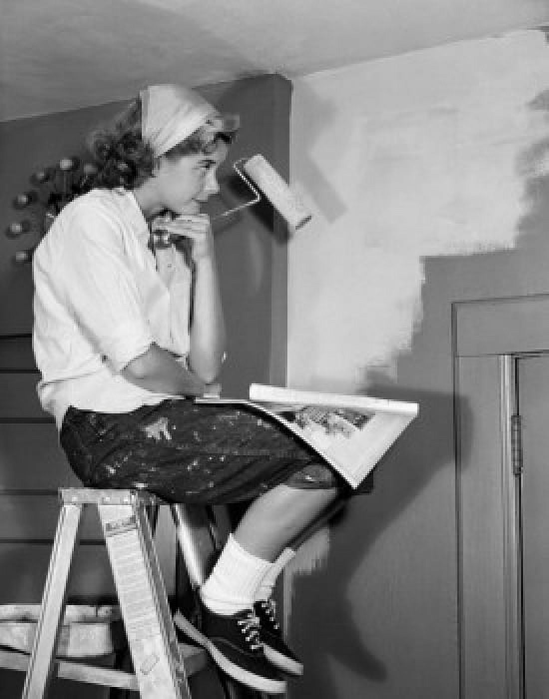 Woman sitting on ladder with paint roller Canvas Art - (24 x 36)
