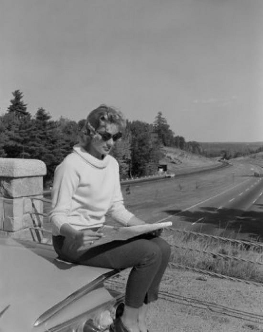Woman sitting on rear of car studying map Canvas Art - (24 x 36)