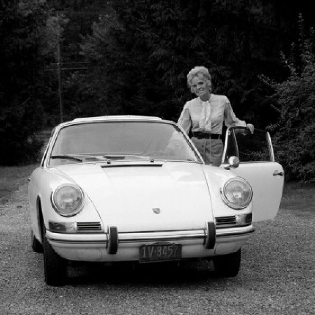 Woman standing by car Canvas Art - (18 x 24)