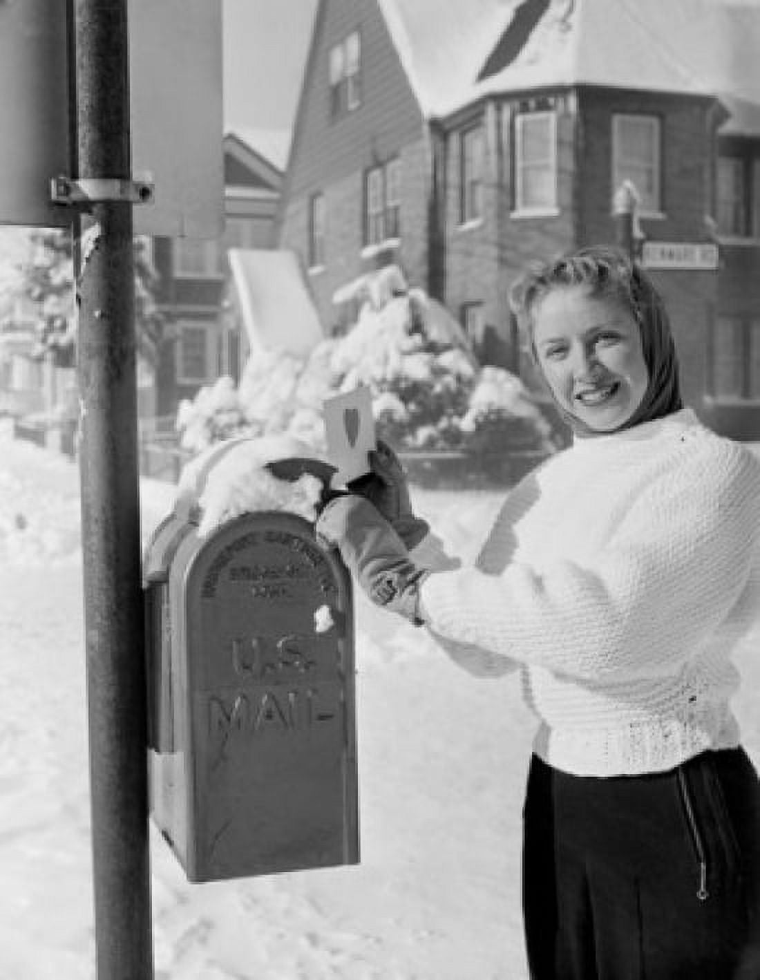 Woman standing in front of mail box holding valentine card Canvas Art - (24 x 36)