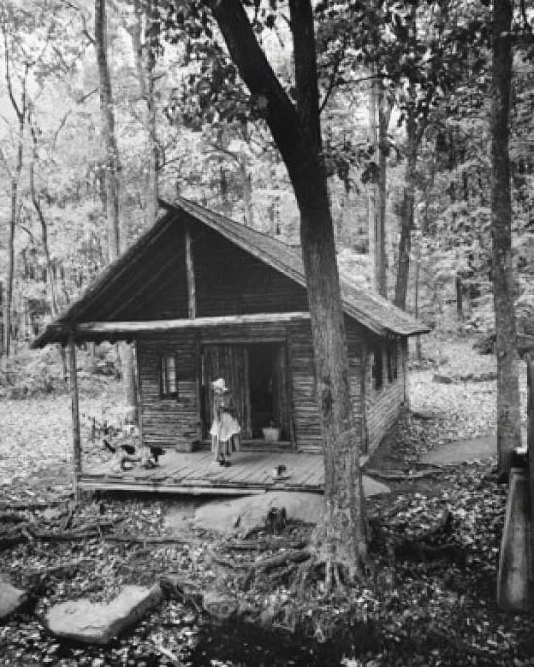 Woman standing with a dog on the porch of a log cabin Canvas Art - (24 x 36)
