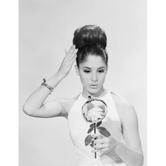 Woman studying hair-do in hand mirror Poster Print (24 x 36)