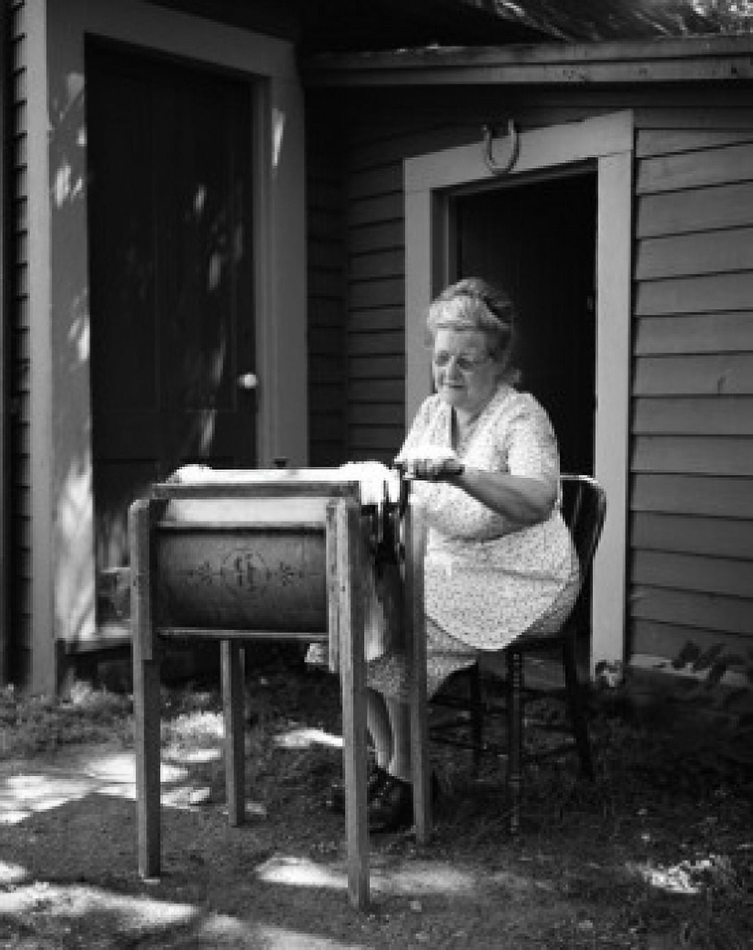 Woman using antique washing machine Canvas Art - (18 x 24)
