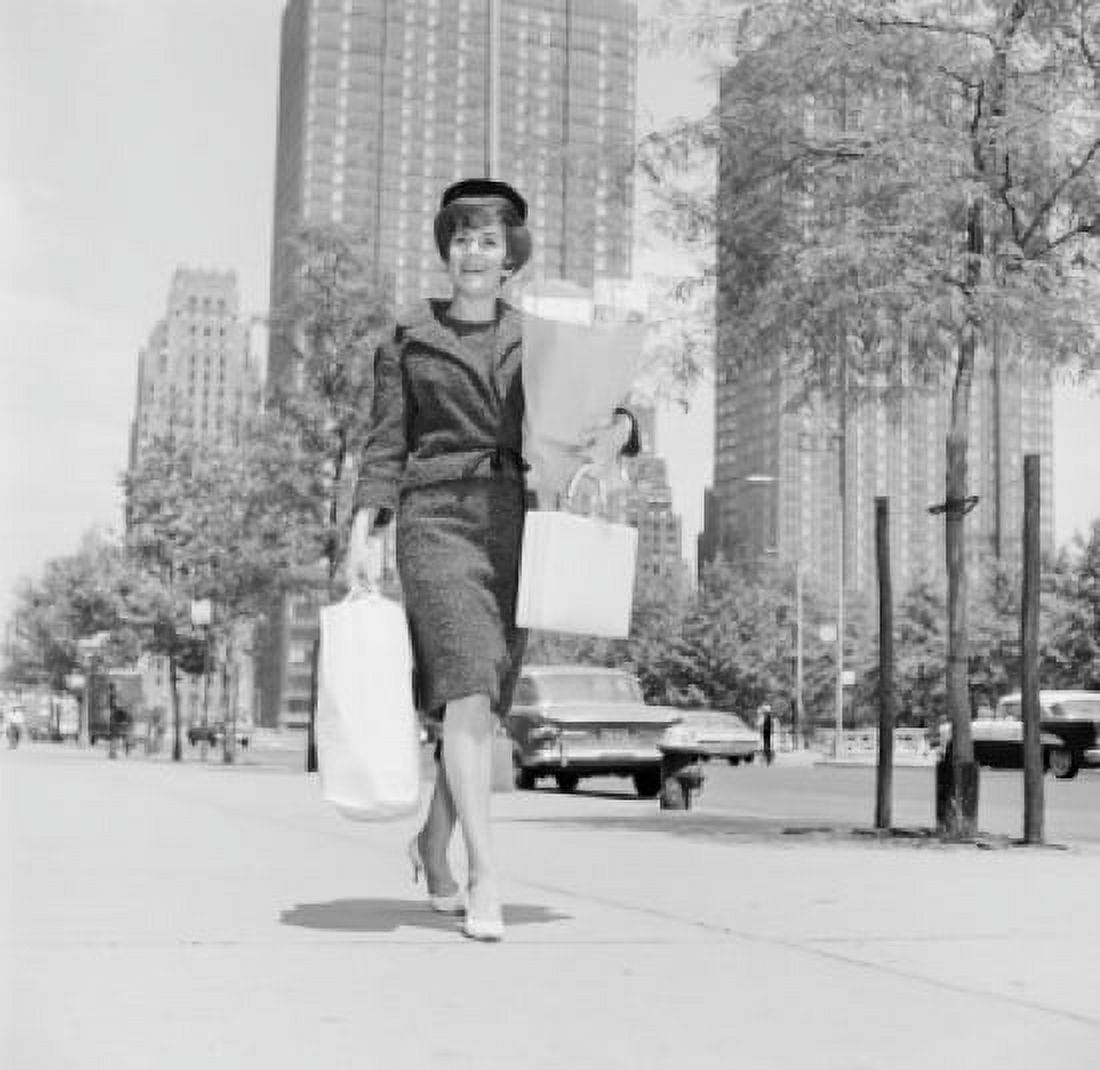Woman walking on street with shopping bags Canvas Art - (24 x 36)