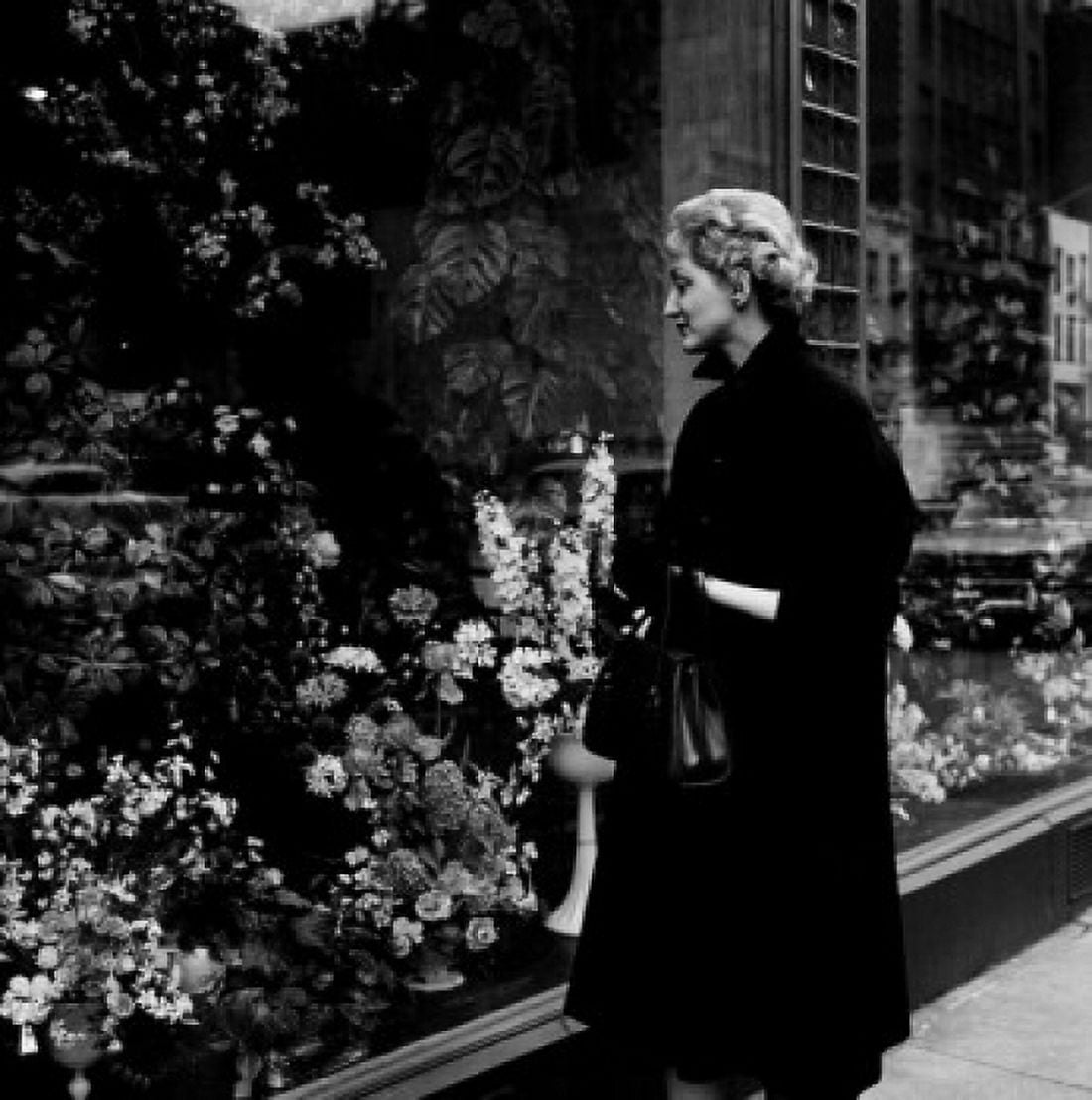 Woman watching window display with flowers Canvas Art - (18 x 24)