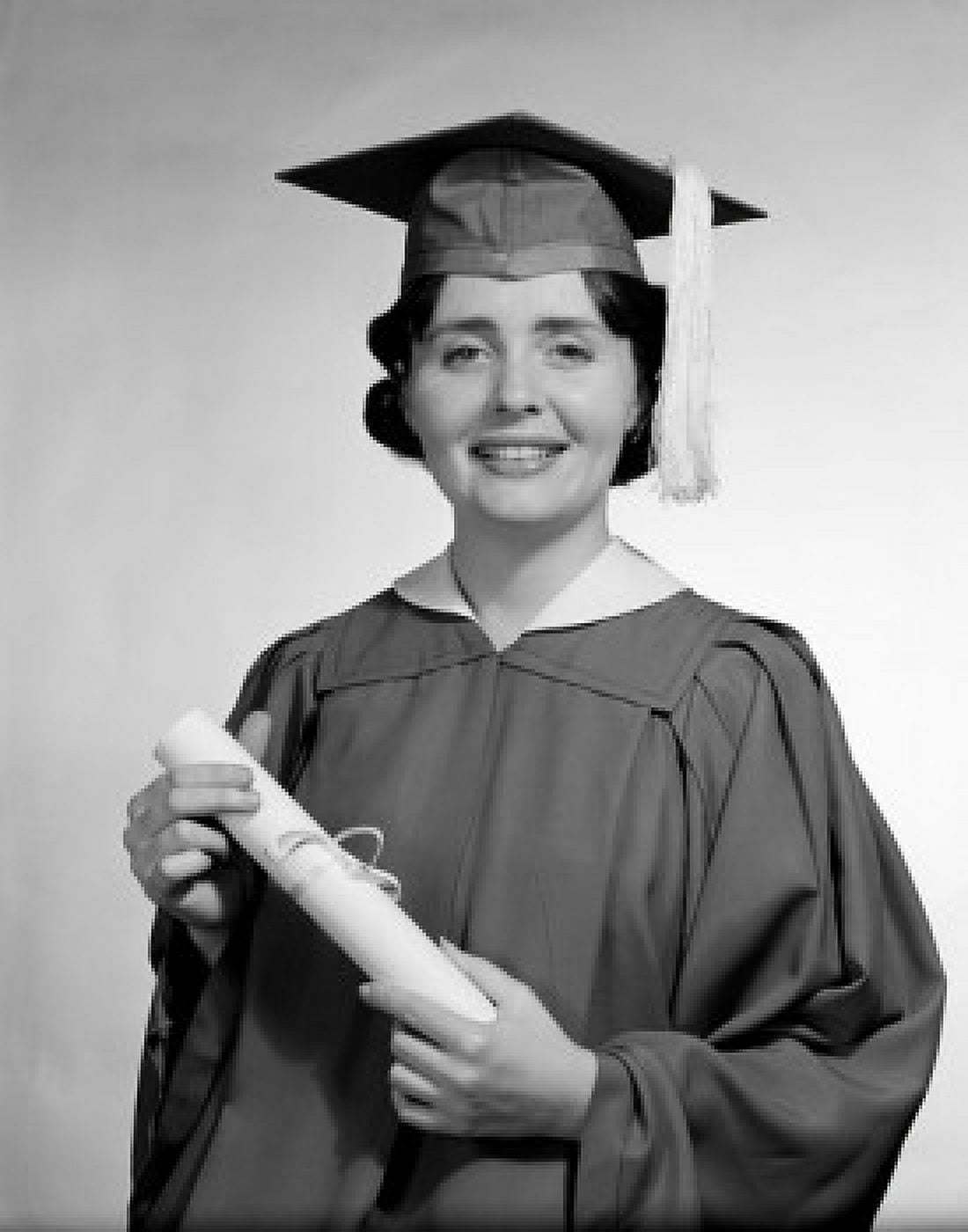 Woman wearing graduation gown holding diploma Canvas Art - (18 x 24)