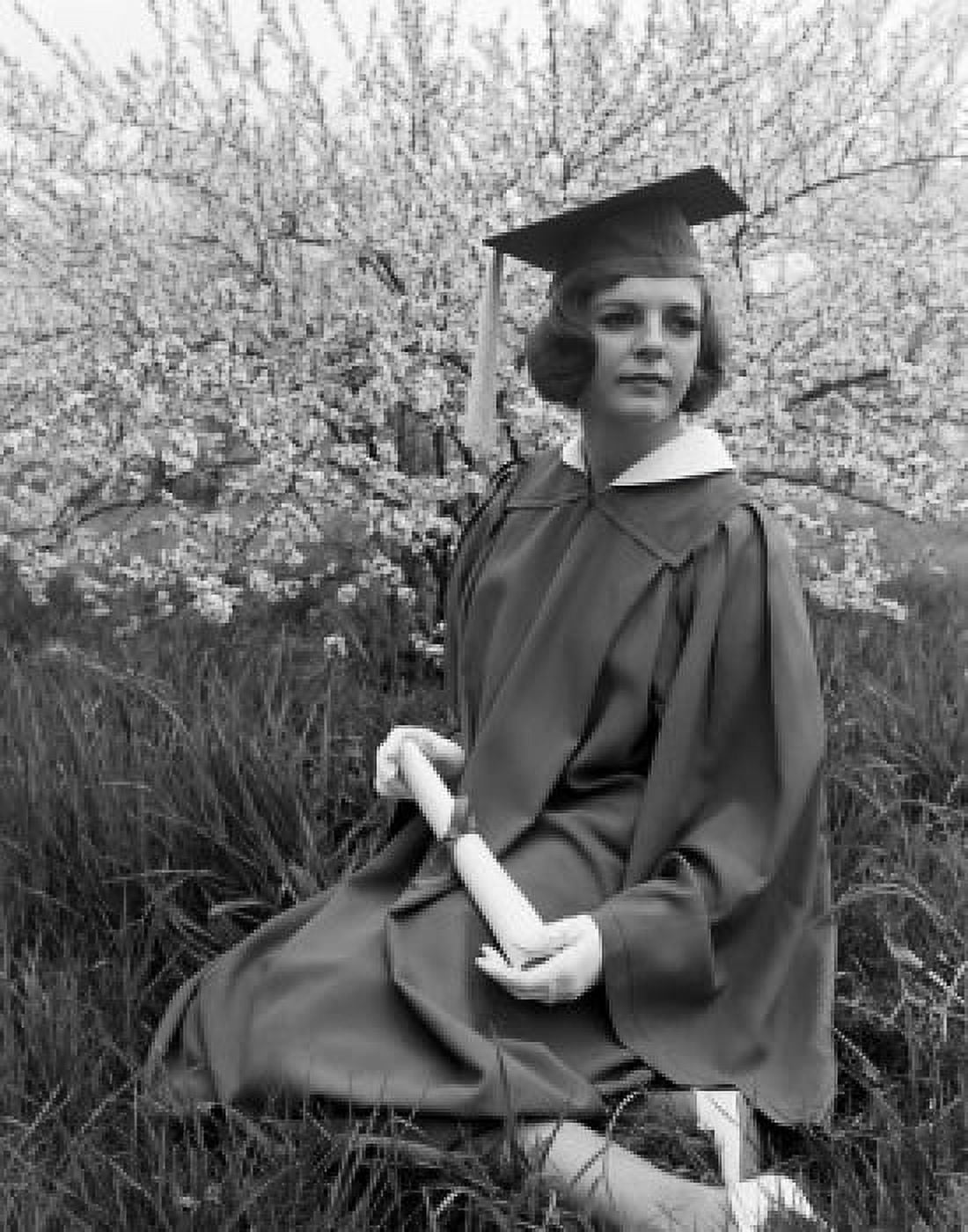 Woman wearing graduation gown sitting in garden Canvas Art - (24 x 36)
