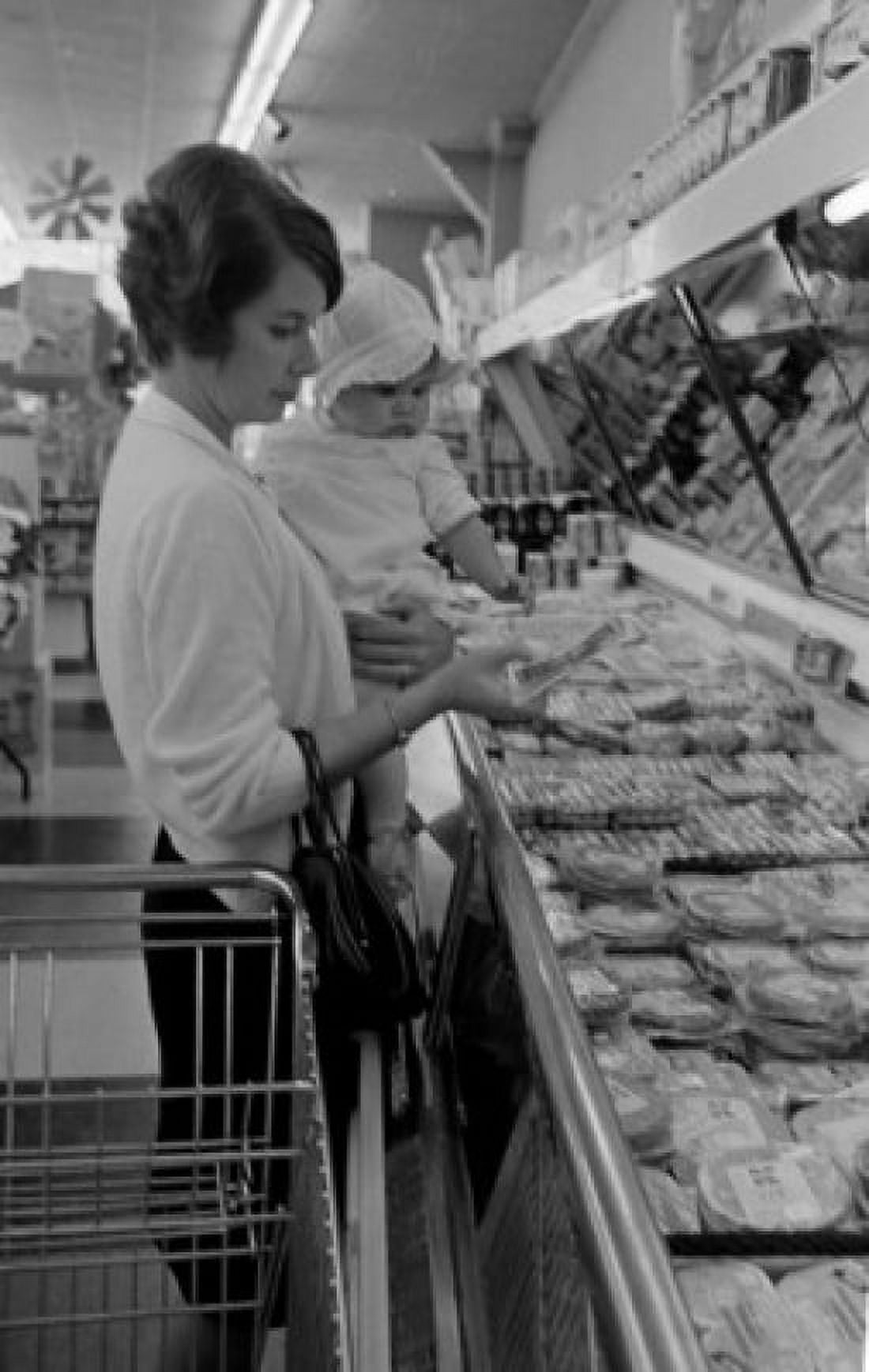 Woman with baby girl shopping in supermarket Canvas Art - (24 x 36)