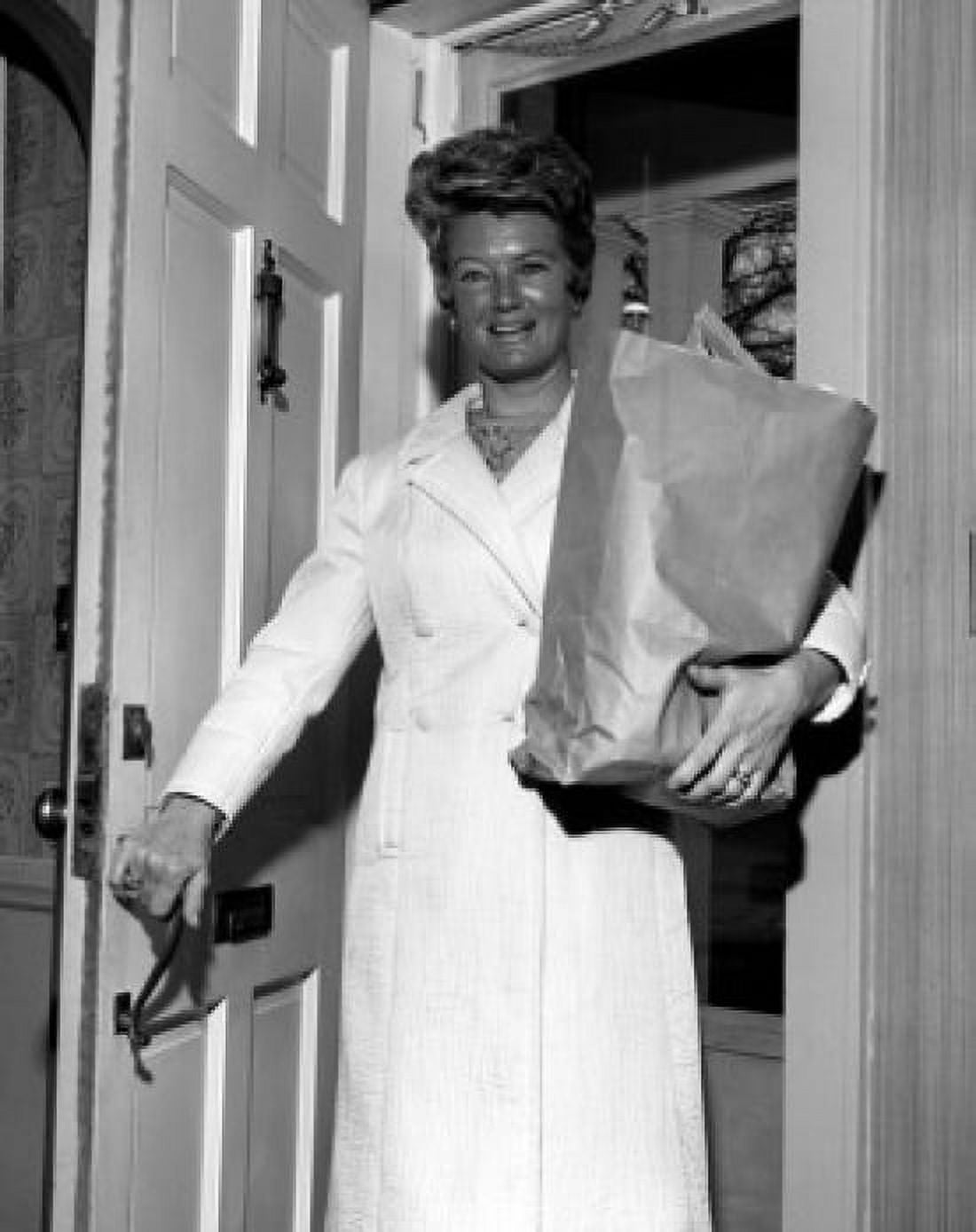 Woman with grocery bag in doorway Canvas Art - (18 x 24)