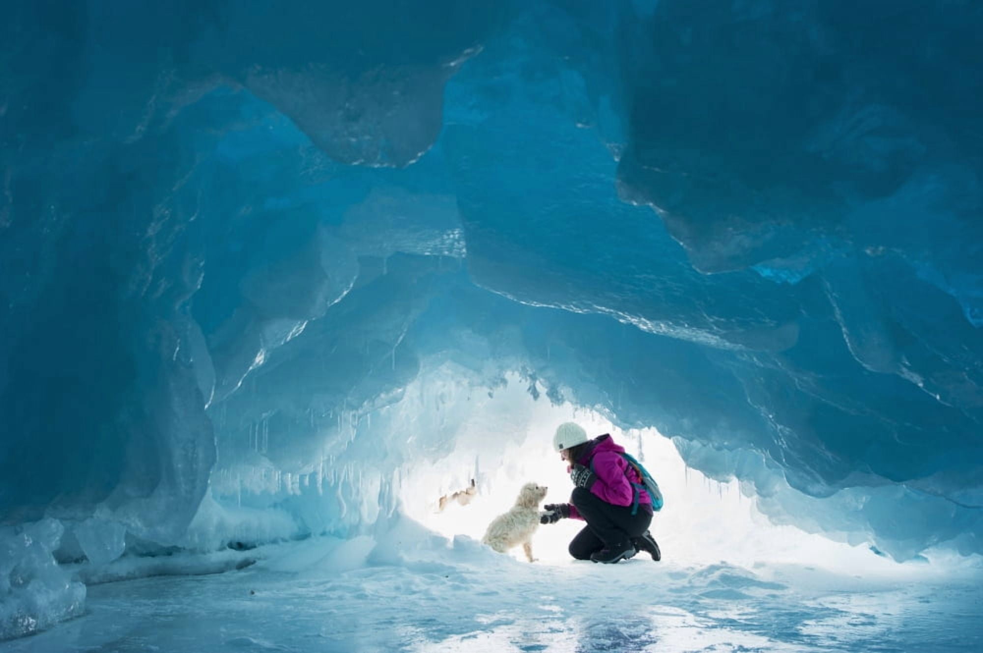 Woman with her pet dog inside a natural ice cave on frozen Lake Superior in winter Ontario Canada Canvas Art - James Smedley Design Pics (38 x 24)