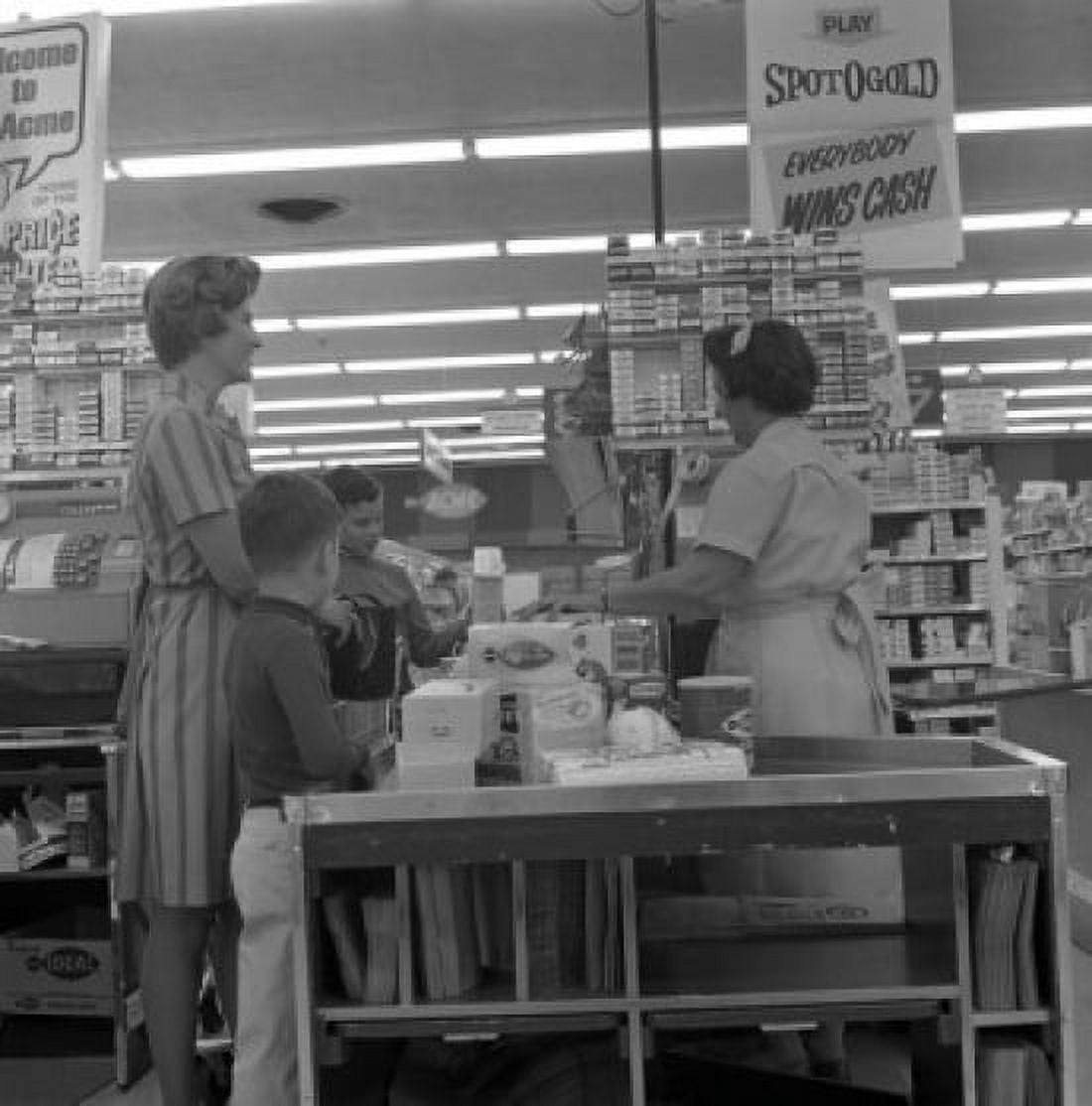 Woman with two sons at cash register in supermarket Canvas Art - (24 x 36)