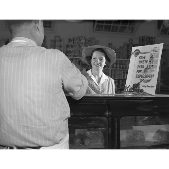 Women At Grocery Store Meat Counter. A Sign On A Grocery Store Counter Reads ' Housewives-Save Waste Fats For