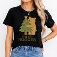 thumbnail image 1 of Women's Black T-Shirt Graphic Tees "Tree Hugger Bear With Christmas Tree" Holiday & Pet Design Shirts S-5XL Casual Daily Tops, 1 of 5