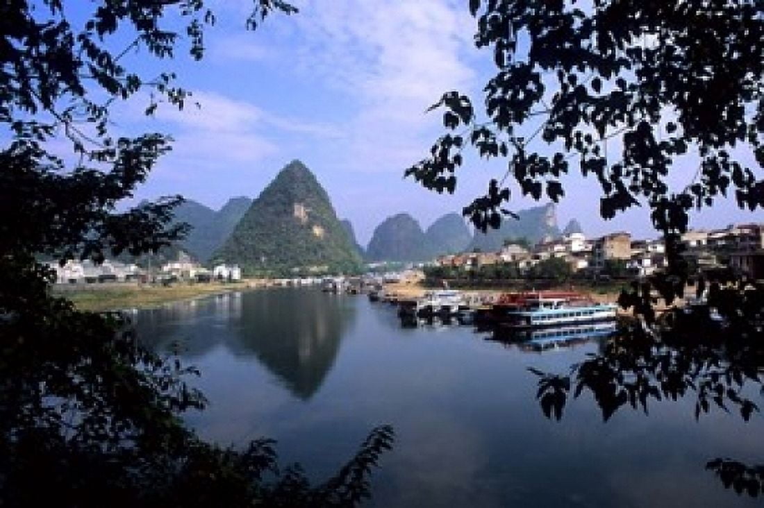 Wonderful ragged Limestone Mountains and Li River and city life of Yangshuo area of China Canvas Art - Bill Bachmann DanitaDelimont (18 x 12)