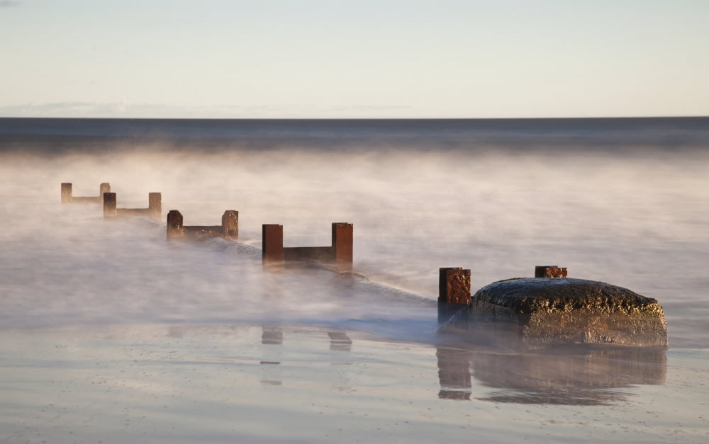 Wooden Posts And Boulders Immersed In Water At The Coast Northumberland England Canvas Art - John Short Design Pics (19 x 12)