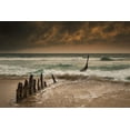 thumbnail image 1 of Wooden posts on a beach with a boat being tossed in the water and waves crashing into the sand under a cloudy sky; Queen, 1 of 4