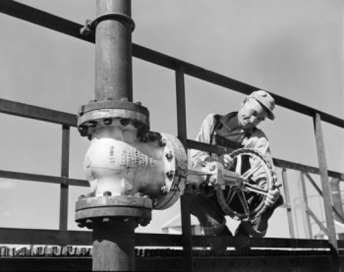 Worker adjusting valve on pipeline Canvas Art - (24 x 36)