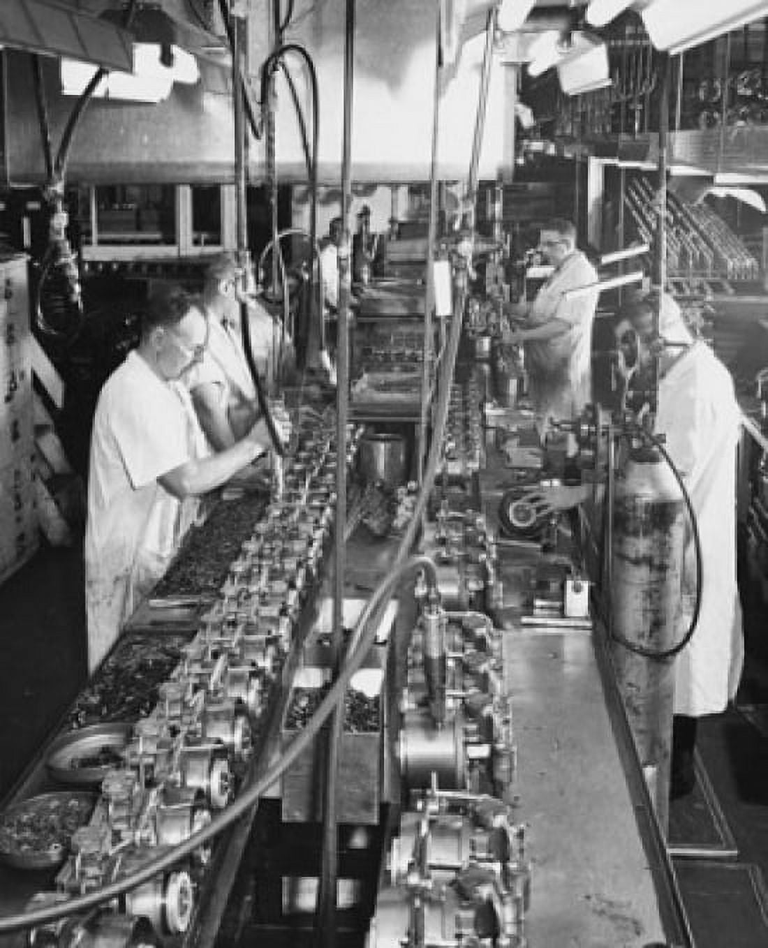 Workers assembling the motor and pump of a household refrigerator unit Canvas Art - (18 x 24)