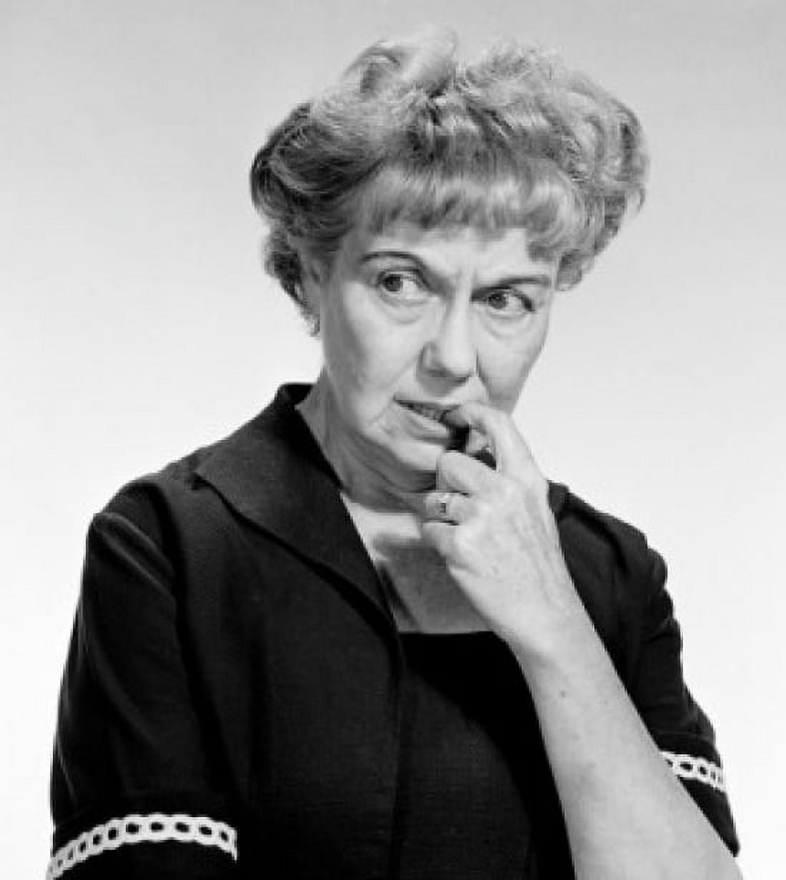 Worried mature woman biting her fingernail and looking away studio shot Canvas Art - (24 x 36)