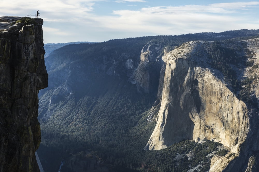 A Yosemite National Park visitor stands at Taft Point which overlooks Yosemite Valley and El Capitan California United States of America Canvas Art - Tracy Barbutes Design Pics (19 x 12)