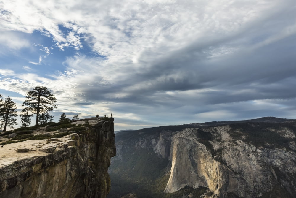 A Yosemite National Park visitor stands at Taft Point which overlooks Yosemite Valley and El Capitan California United States of America Canvas Art - Tracy Barbutes Design Pics (19 x 12)