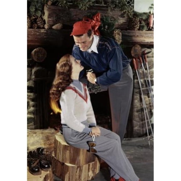 Young Couple Smiling Near a Fireplace Poster Print - 18 x 24 in.